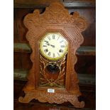 A "Gingerbread" style wall Clock, the glazed door panel with gold floral relief, by Felix,