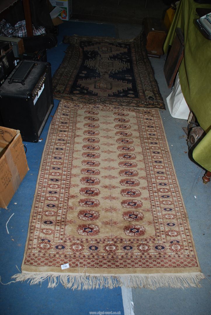 A dark blue and grey rug, a/f ,60'' x 40'' together with a tan ground bordered,