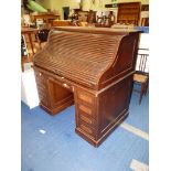 An Oak scroll roll-top double pedestal desk having a nicely fitted interior with numerous pigeon