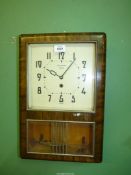 A Richmond eight day Art Deco style wall Clock with pendulum, 18 1/2" tall x 12" wide x 4" deep.