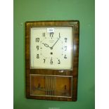 A Richmond eight day Art Deco style wall Clock with pendulum, 18 1/2" tall x 12" wide x 4" deep.