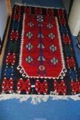 A contemporary black and red ground bordered, patterned and fringed carpet, 6'2'' x 48''.