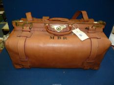 A tan leather replica Gladstone bag with checked lining and with initials M.B.R. to the side.