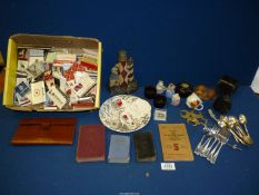 A box of miscellaneous collectibles including old spoons, forks, matches, camera lens etc.