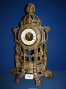 An ornate brass effect Mantle clock, 16" tall.