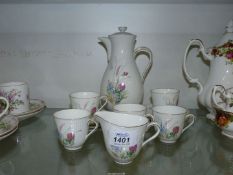 A Swedish china part coffee set for six, (one cup missing).