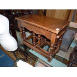 A nest of three Oak occasional Tables having turned legs and perimiter stretchers,