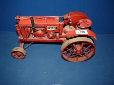A McCormick Deering Farmall model tractor made of tin.