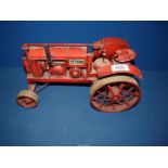 A McCormick Deering Farmall model tractor made of tin.