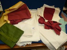 A quantity of lining fabric in various colours including cream, burgundy and gold,