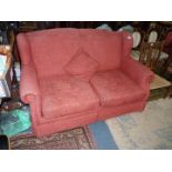 A patent action terracotta coloured upholstered Bed Settee.