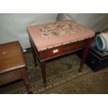 A Mahogany framed piano stool standing on tapering square legs terminating in spade feet,