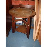 An Oak Arts & Crafts circular occasional table having recessed beaten copper centre to the top,