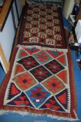 Two geometric bordered and patterned rugs, one being 60'' x 33'' and the other 65'' x 37''.