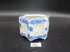 An oriental blue and white hexagonal bowl with pierced detail, 3 1/2'' tall, no marks to the base.