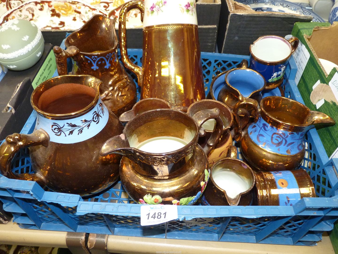 A quantity of copper lustre jugs, bowl, mugs and a swing lid water jug.