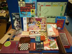 A quantity of board and card games including Monopoly, Mastermind, Scrabble, chess pieces etc.
