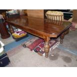 A most substantial Oak Hall or Library Centre Table standing on heavy turned legs and having canted