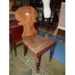 A Mahogany solid seated hall Chair having a fretworked shaped back and turned front legs.