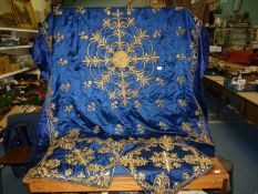 A blue ground, gold thread embroidered table cover, approx.