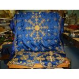 A blue ground, gold thread embroidered table cover, approx.