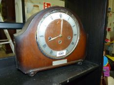 An Oak finished Mantle clock having chrome face, with key,
