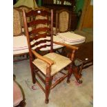 An elegant Ladderback Elbow Chair having turned front legs and stretchers and with a woven Seagrass