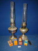 Two chrome Oil lamps with glass chimneys and spare mantles and wicks, a/f.