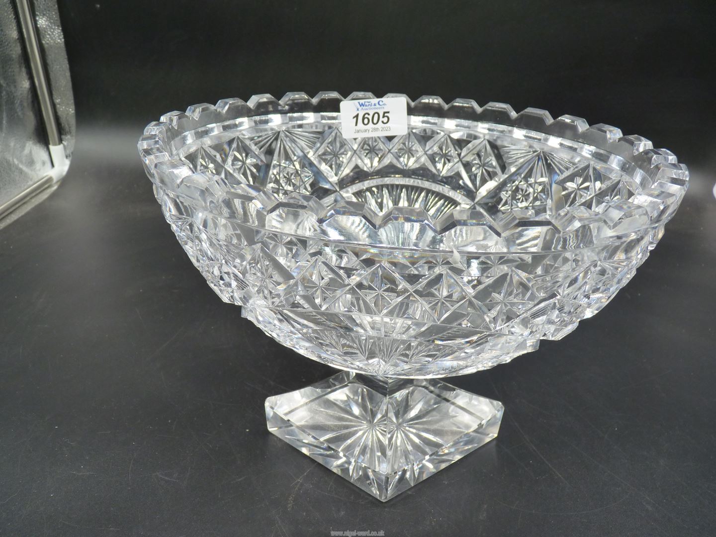 A cut glass oval footed bowl, 7" tall, chip to corner.