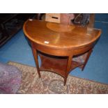 A circa 1900 Demi-lune Flapover Card Table,the tapering square legs united by a lower shelf,