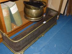 A brass coal bucket and fender.