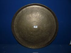 A large brass Charger illustrating dogs and with floral embossed pattern, 20" diameter.