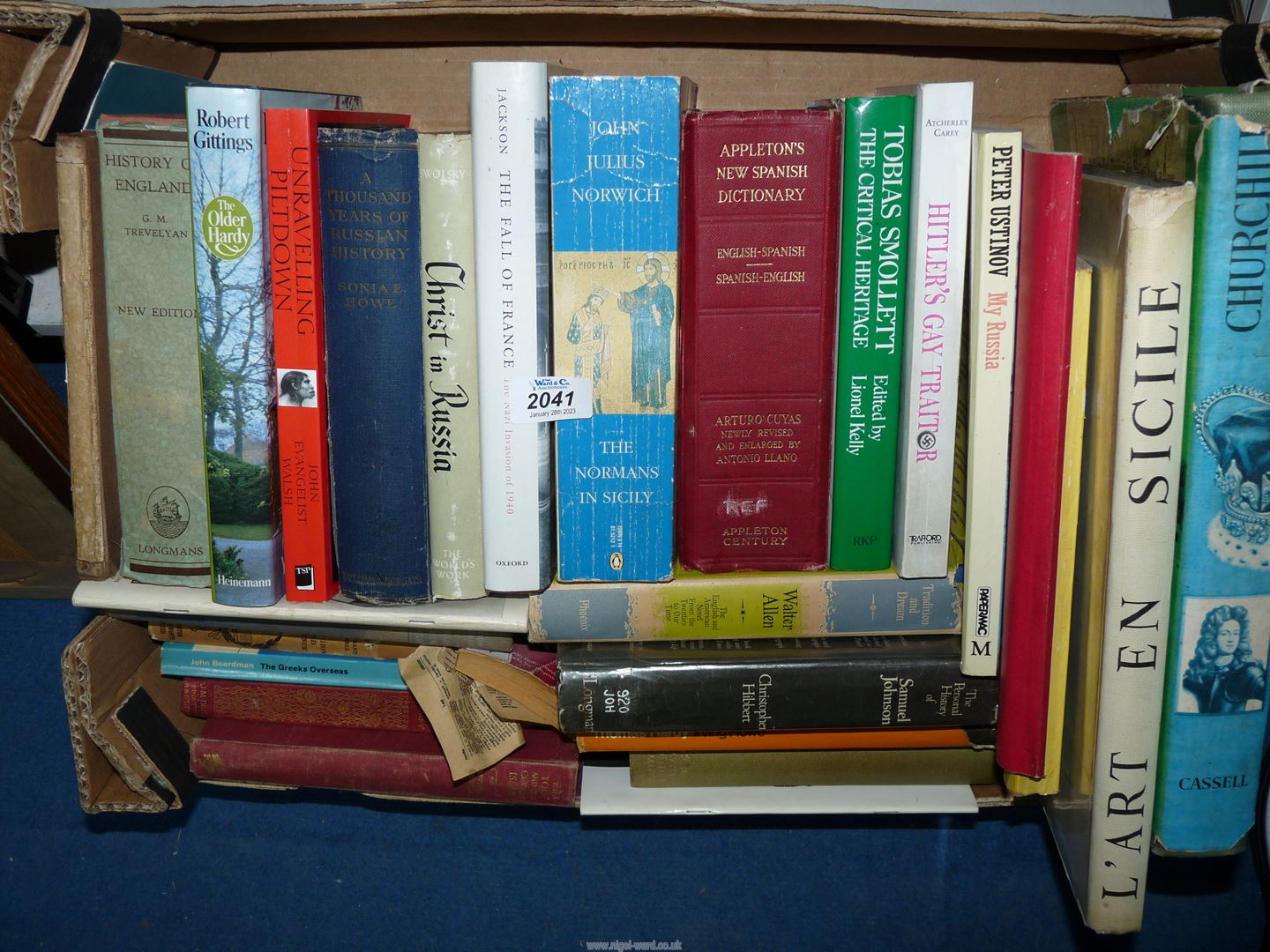 A box of books including 'Christ in Russia', 'L'Art en Sicile', 'Unraveling Piltdown',