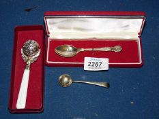 A white metal rattle, a Sheffield silver teaspoon and a plated mustard spoon.