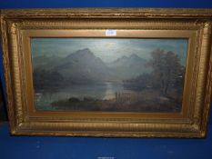 An ornate gilt framed Oil on canvas depicting a river landscape with two figures standing on the