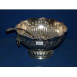 A large silver plated Punch Bowl and a ladle, decorated with roses.