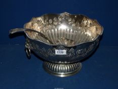 A large silver plated Punch Bowl and a ladle, decorated with roses.