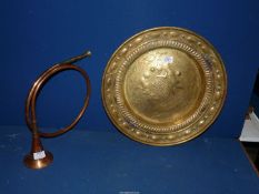 A copper horn and a brass charger/plate.