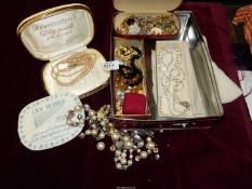 A quantity of costume jewellery including pearl necklaces, brooches etc.