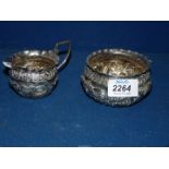 A small Silver cream jug and sugar bowl, London 1892, makers Josiah Williams & Co., 127 gms.