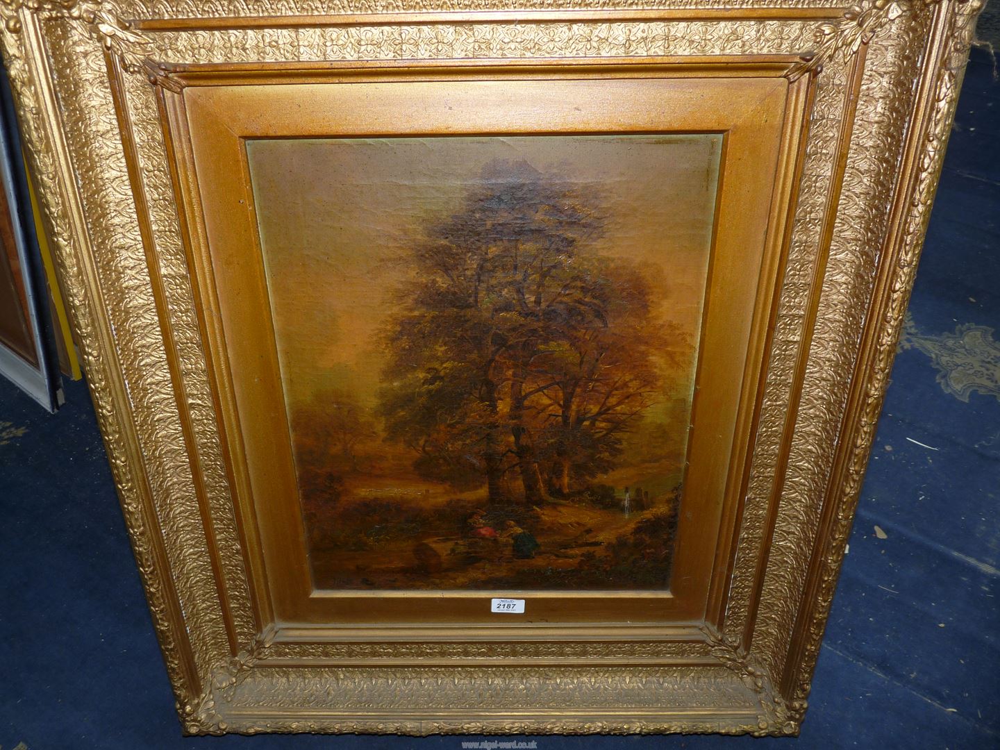 A heavy ornate gilt framed Oil on canvas depicting a woodland scene with two young girls seated by