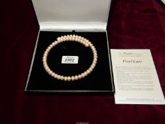 A pearl style choker necklace by The Pearl Co., boxed.