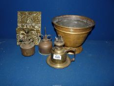 A small quantity of brass to include a letter holder with rural scene in relief, two oil cans,