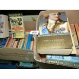 Two boxes of paperback novels including 'Joan of Arc' by Mary Gordon, 'Wine and War,