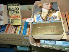 Two boxes of paperback novels including 'Joan of Arc' by Mary Gordon, 'Wine and War,