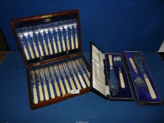 A wooden canteen of twelve fish knives and forks and two boxed fish serving knife and fork sets.