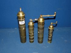 Four brass Greek Pepper Mills for display purposes only, the largest missing its handle.