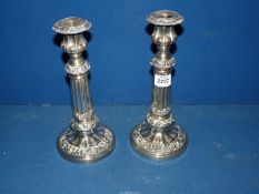 A pair of E.P.N.S. candlesticks, highly decorated, 10 1/2" tall extending to 12 1/2" .