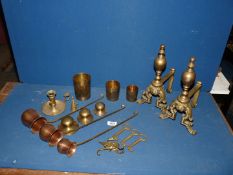 A pair of brass fire dogs, brass chamber stick, three copper measures, etc.