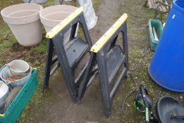 Two plastic trestle stands.